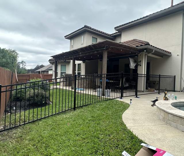 Black metal fence around a patio