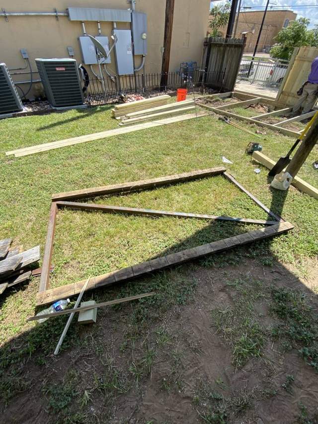 Old frame pulled out with new lumber stacked behind it